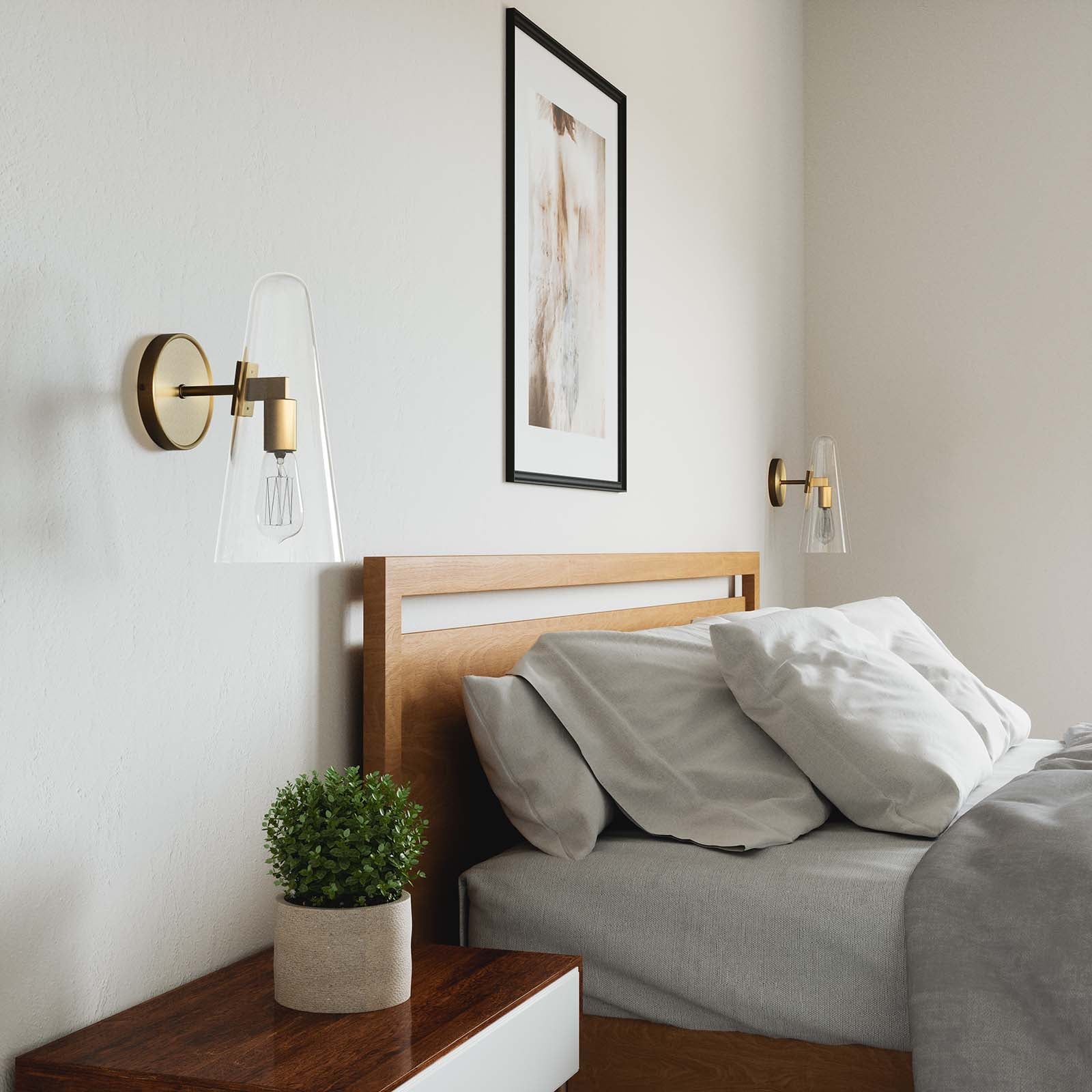 Lámpara de pared de 1 luz latón satinado y vidrio transparente Skander en una habitación.