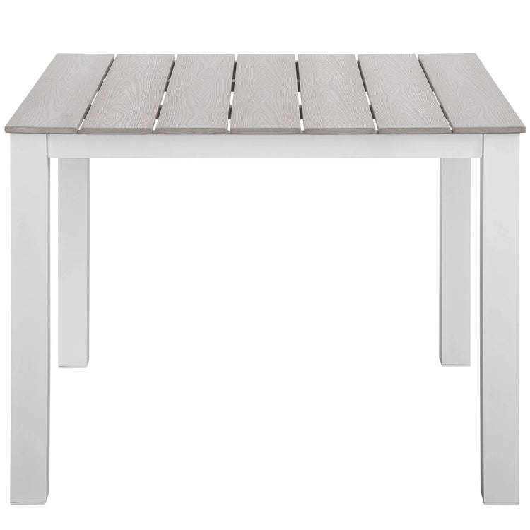 Mesa de comedor exterior de 40” Lore color gris claro de frente.